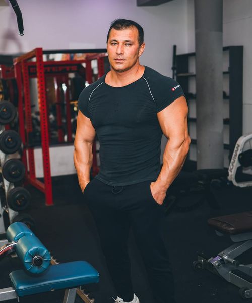 Man focusing on functional training movements in dark studio